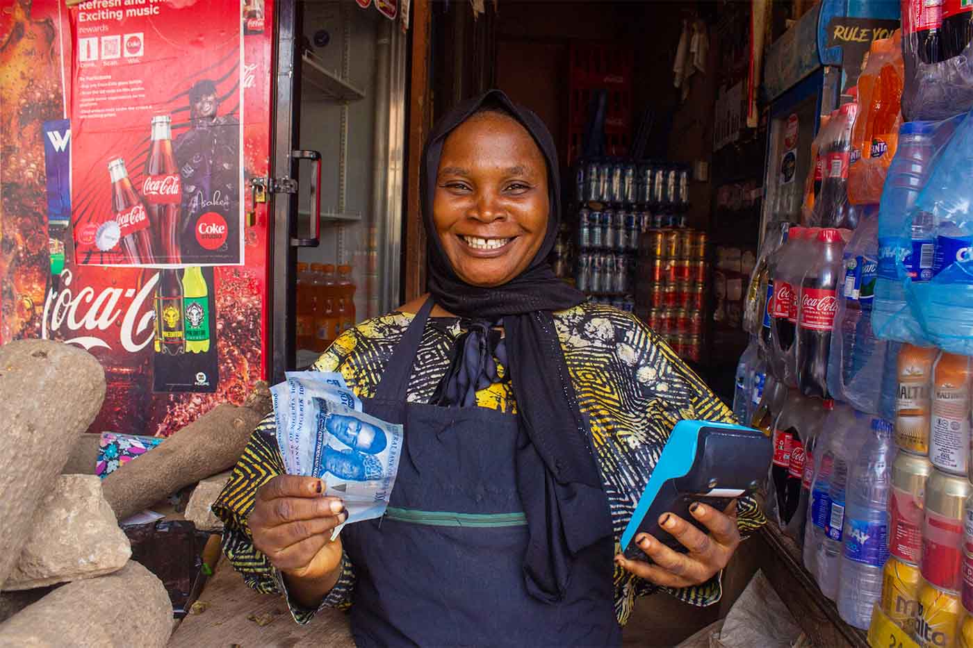 Nigeria Market Woman Holding Cash Naira Money and POS Machine Smiling
