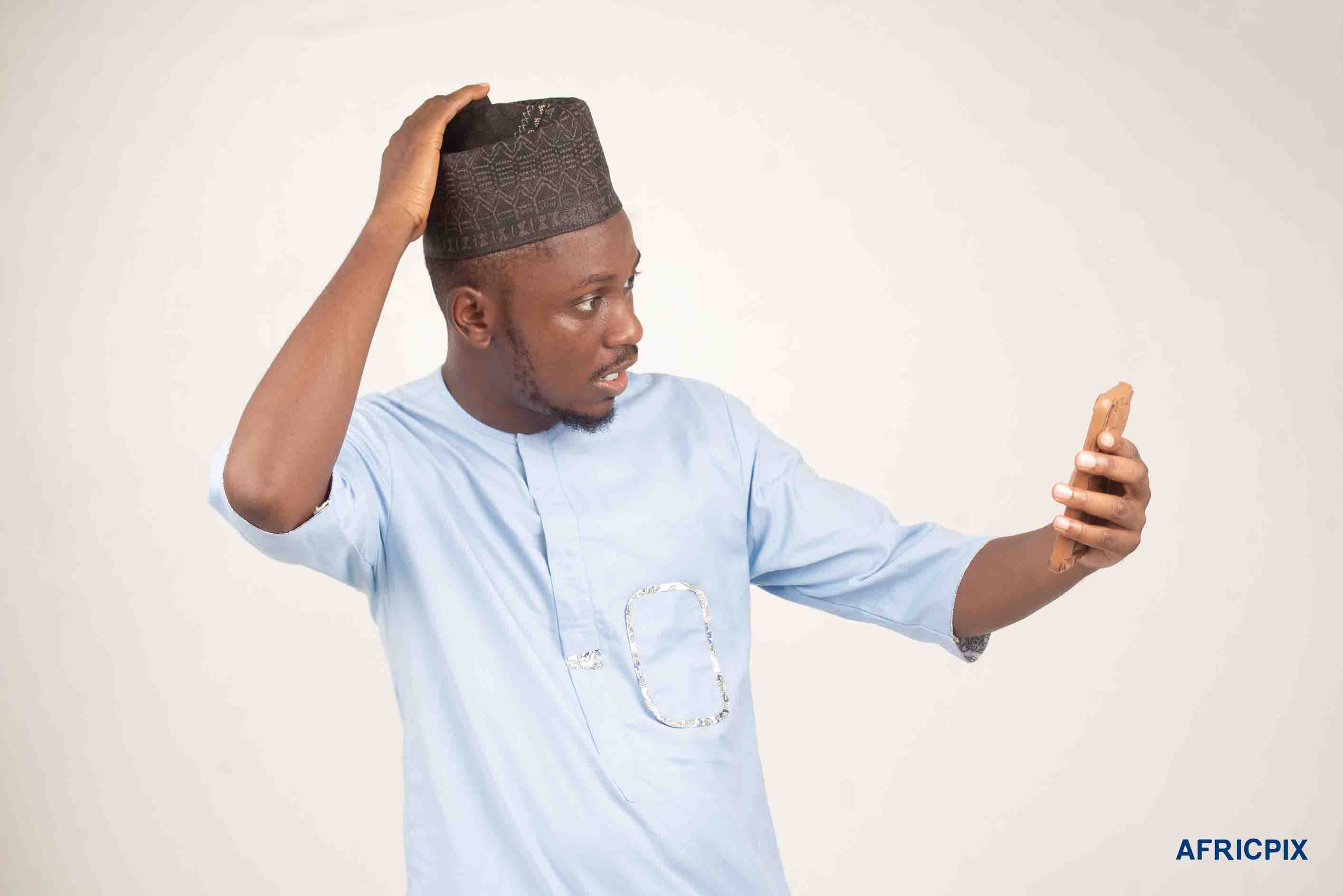 Nigeria Hausa Man Holding phone Surprise