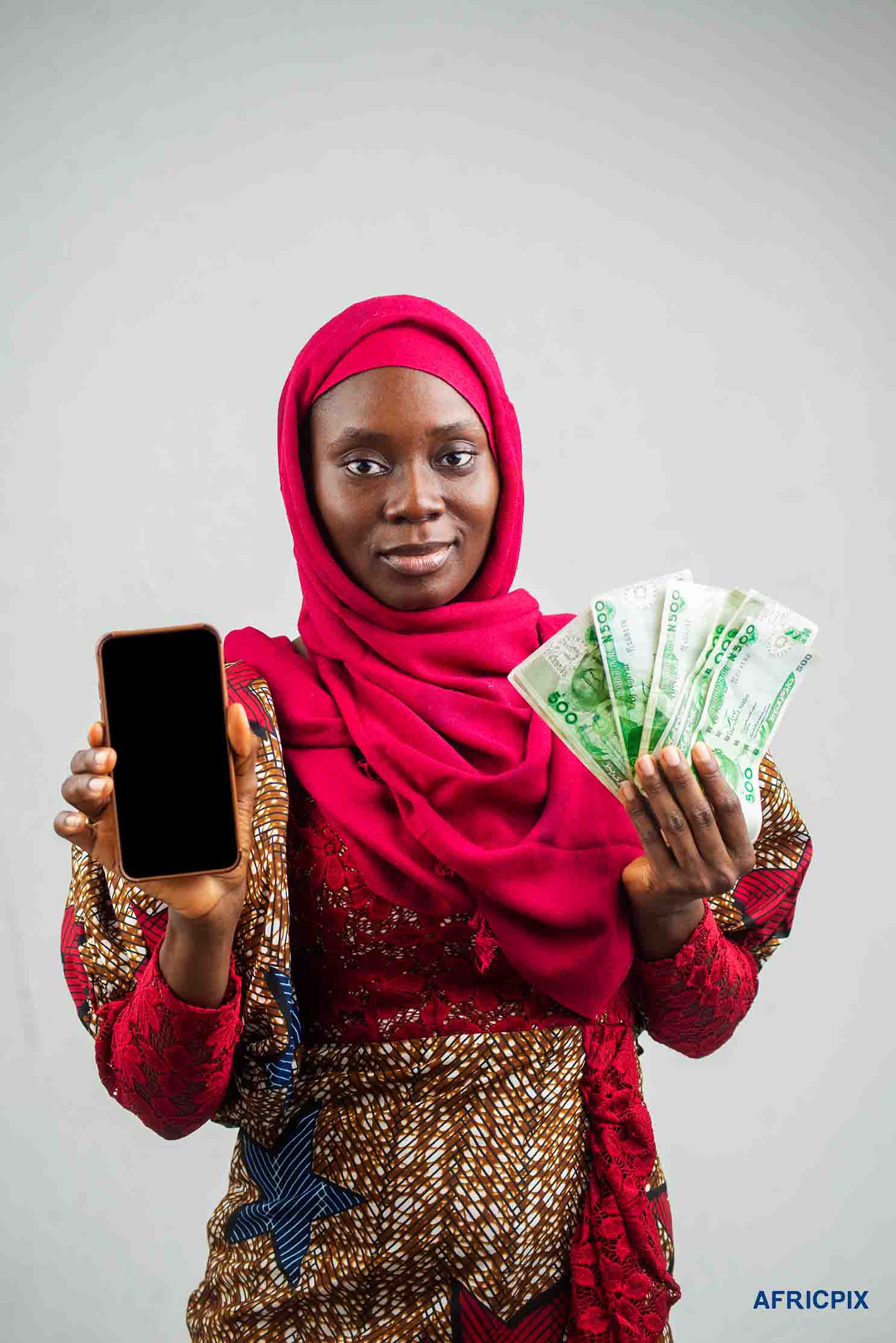 Nigeria Woman Hausa Holding Money and Phone