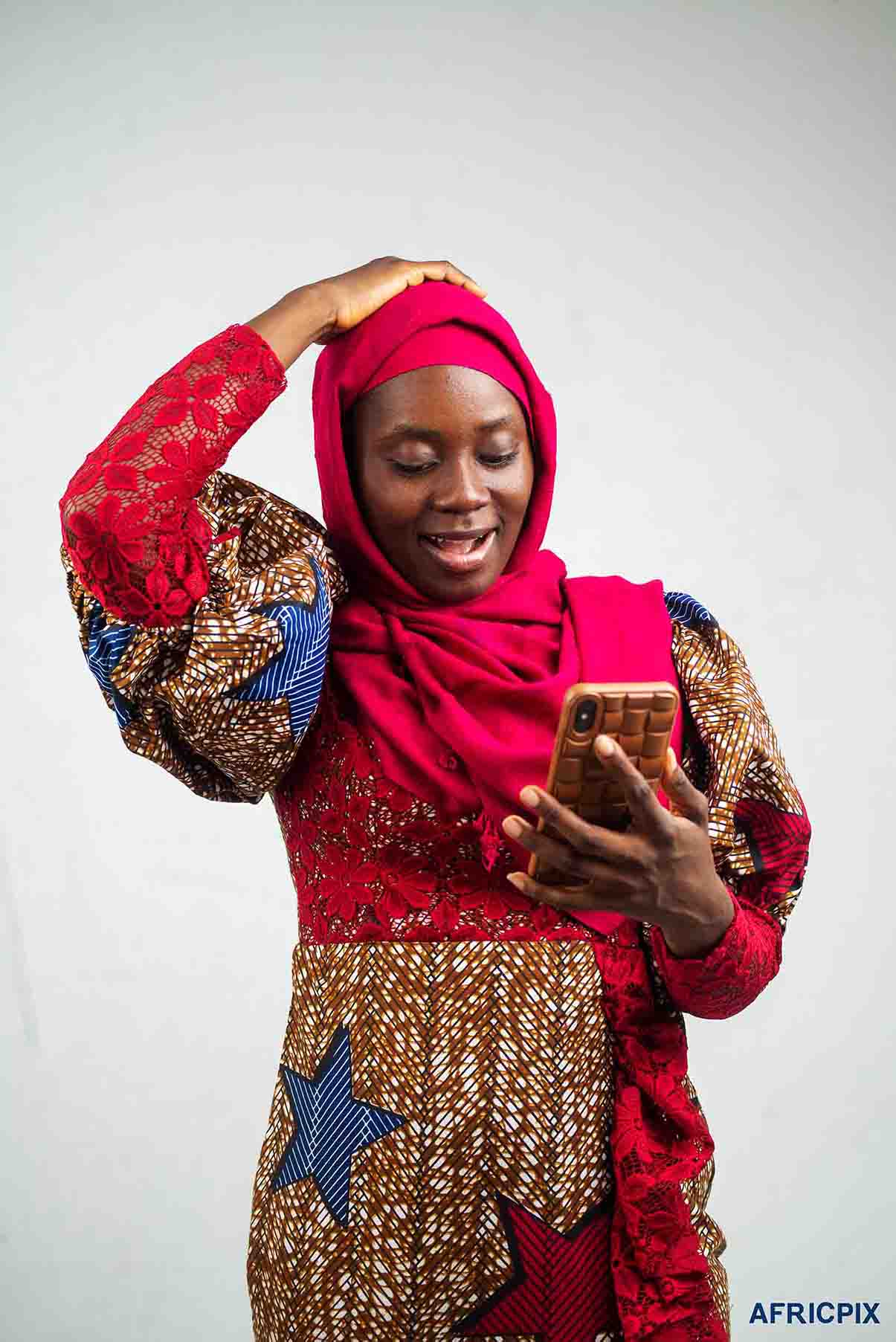 Nigeria Woman Hausa Holding Phone Looking_Surprise_Africpix
